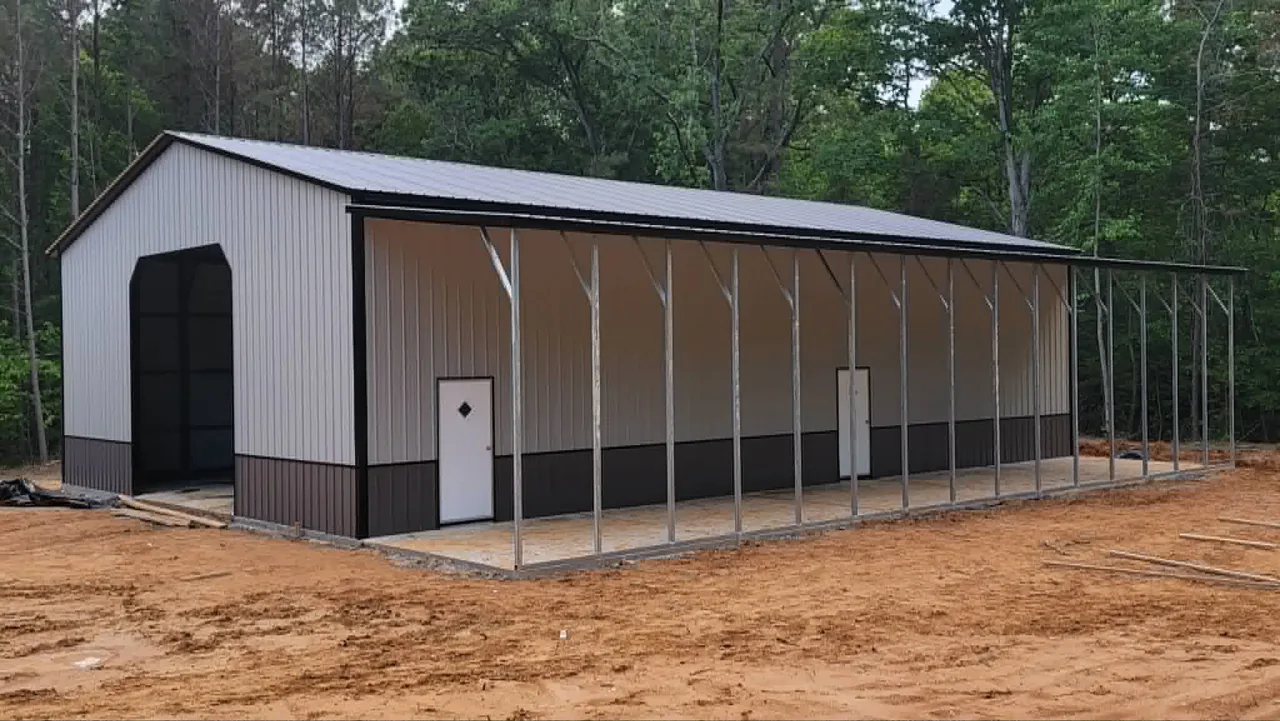 Tan and white metal building with an attached carport