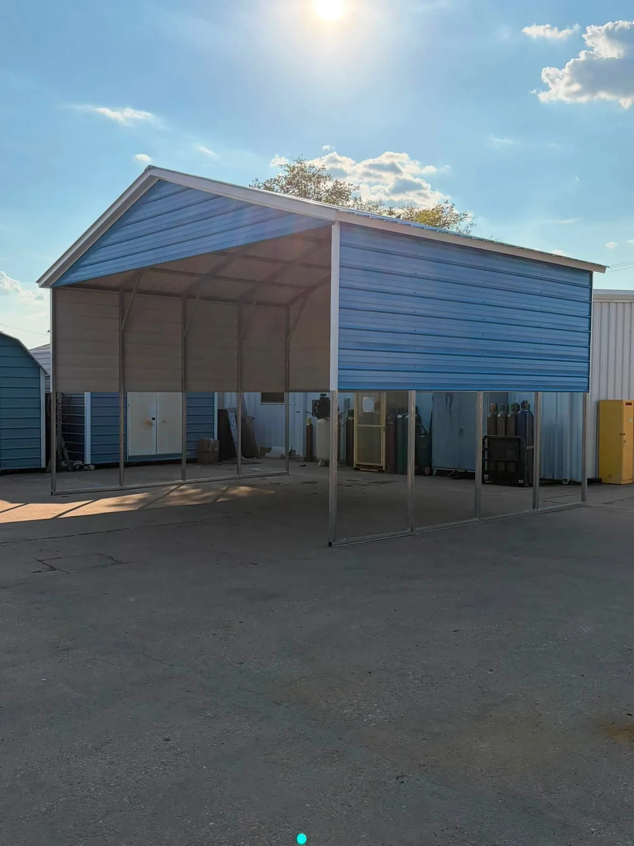 Blue metal carport with an open side